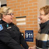 Lynn Blue greeting a GVPD officer at the Lynn M. Blue Connection Naming Ceremony